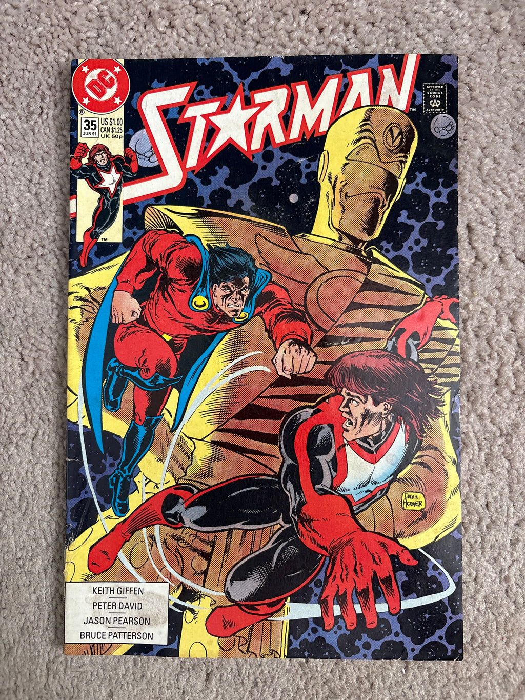 Front cover of DC Comics Starman #35, featuring Starman and a golden robot.